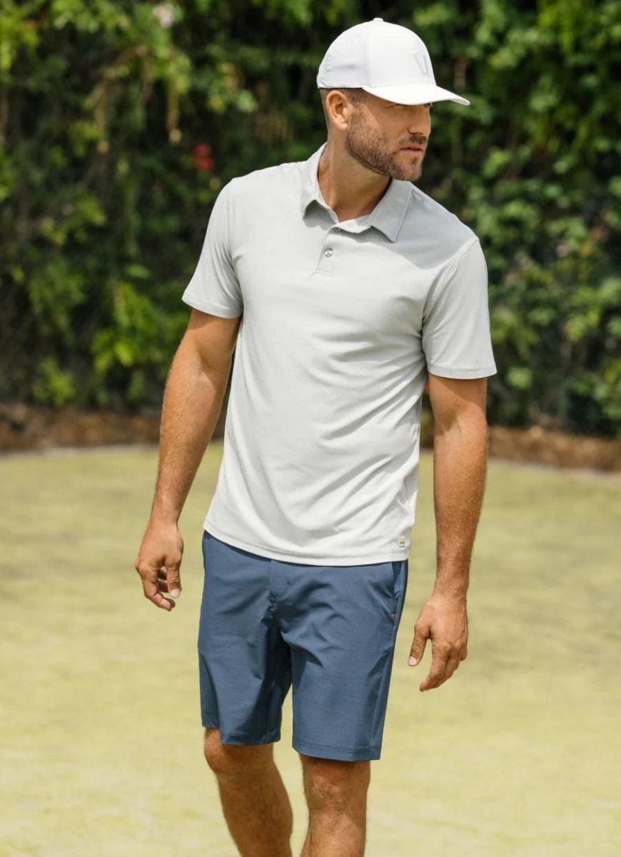 Vuori Men's Strato Tech Polo in Platinum Heather Model Shown Posing Outside