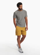 vuori Men's Strato Tech Tee in Grey Full Model Angled Side View with Hand in Pocket