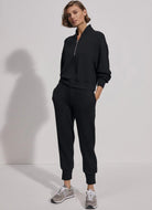 Varley The Slim Cuff Pant 25” in Black Front View with Hand in Pocket