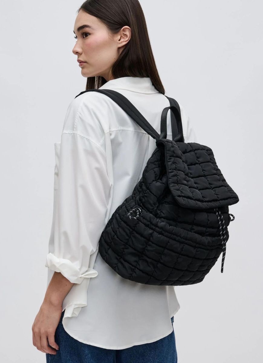 Sol and Selene Vitality Backpack in Black Side View Shown with Model Wearing it with Two Straps