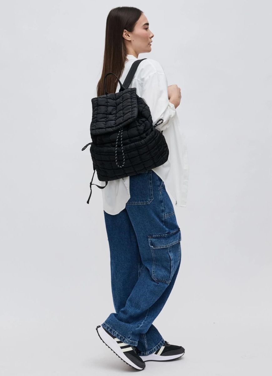 Sol and Selene Vitality Backpack in Black Model Shown Wearing with One Strap Over Shoulder