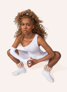 Bala Bangles 2lb. Weights in Sand Model Wearing Them on Her Ankles in a Squat Position