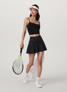 Vuori Baseline Skirt 14.5" in Black Model Holding a Tennis Racquet 