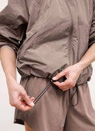 Beyond Yoga Limitless Hooded Jacket in Rosey Taupe Close Up View of Elastic Waist