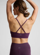 Beyond Yoga Twist Front Strappy Sports Bra in Brilliant Blackberry Back View