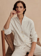 Varley Celeste Button Through Sweat in Ivory Marl Model Sitting on a Chair