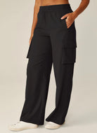 Beyond Yoga City Chic Cargo Pant in Black Waist Down Side View With Hand in Pocket