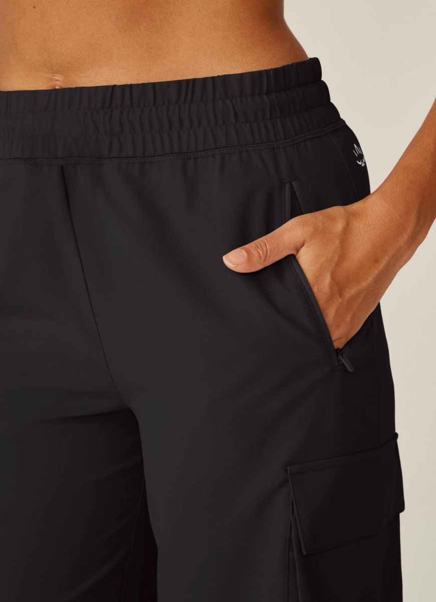 Beyond Yoga City Chic Cargo Pant in Black Close Up View With Hand in Pocket