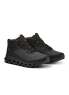 On Cloudroam Waterproof Sneakerboot in Black Angled Side View With Water Droplets on the Shoes