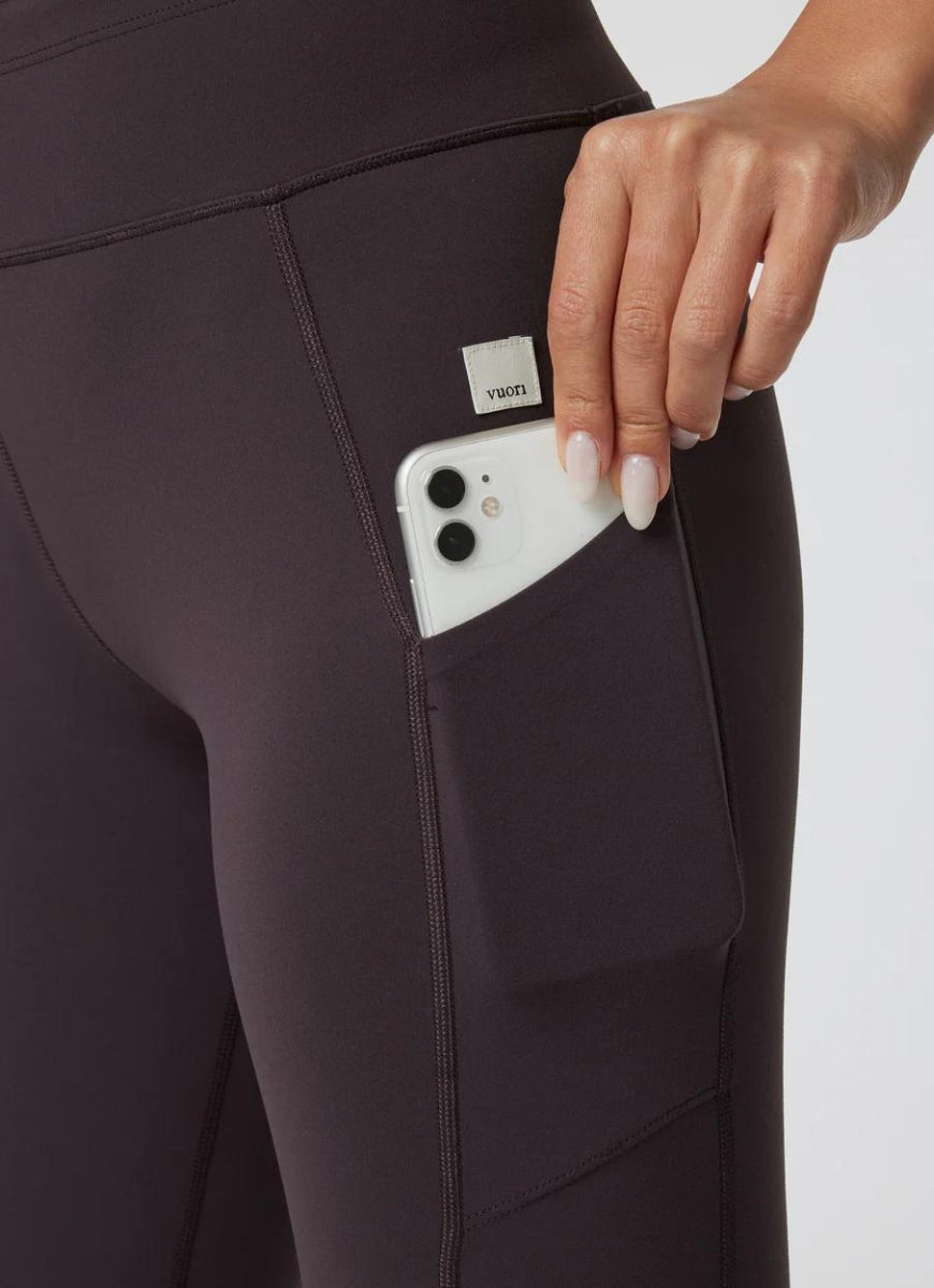 Vuori Daily Pocket Legging in Sangria Close Up View of Mobile Phone in Pocket