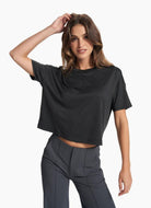 vuori Women's Energy Tee in Black Thigh Up Front View