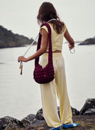 Free People Hot Shot Crossover Set in Sunlit Yellow Back View on Rocky Shoreline