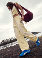 Free People Hot Shot Crossover Set in Sunlit Yellow Side View With Model Shown on Shoreline