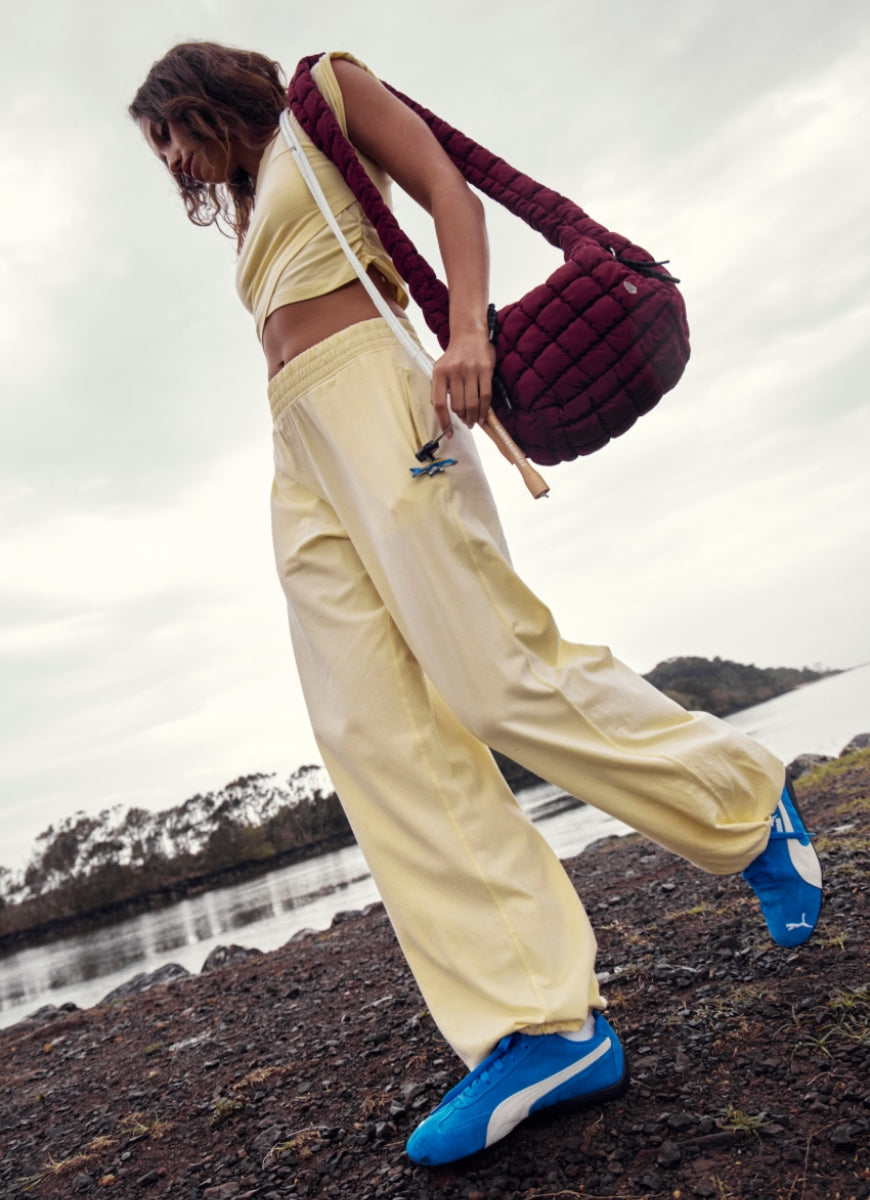 Free People Hot Shot Crossover Set in Sunlit Yellow Side View With Model Shown on Shoreline