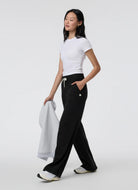 vuori Women's Halo Essential Wideleg Pant in Black Full Length Side View