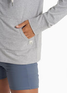 Vuori Women's Halo Performance Hoodie 2.0 in Pale Grey Heather Close Up View of Hand in Pocket