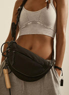 Free People Hit The Trails Sling Bag in Black Shown on Model's Waist