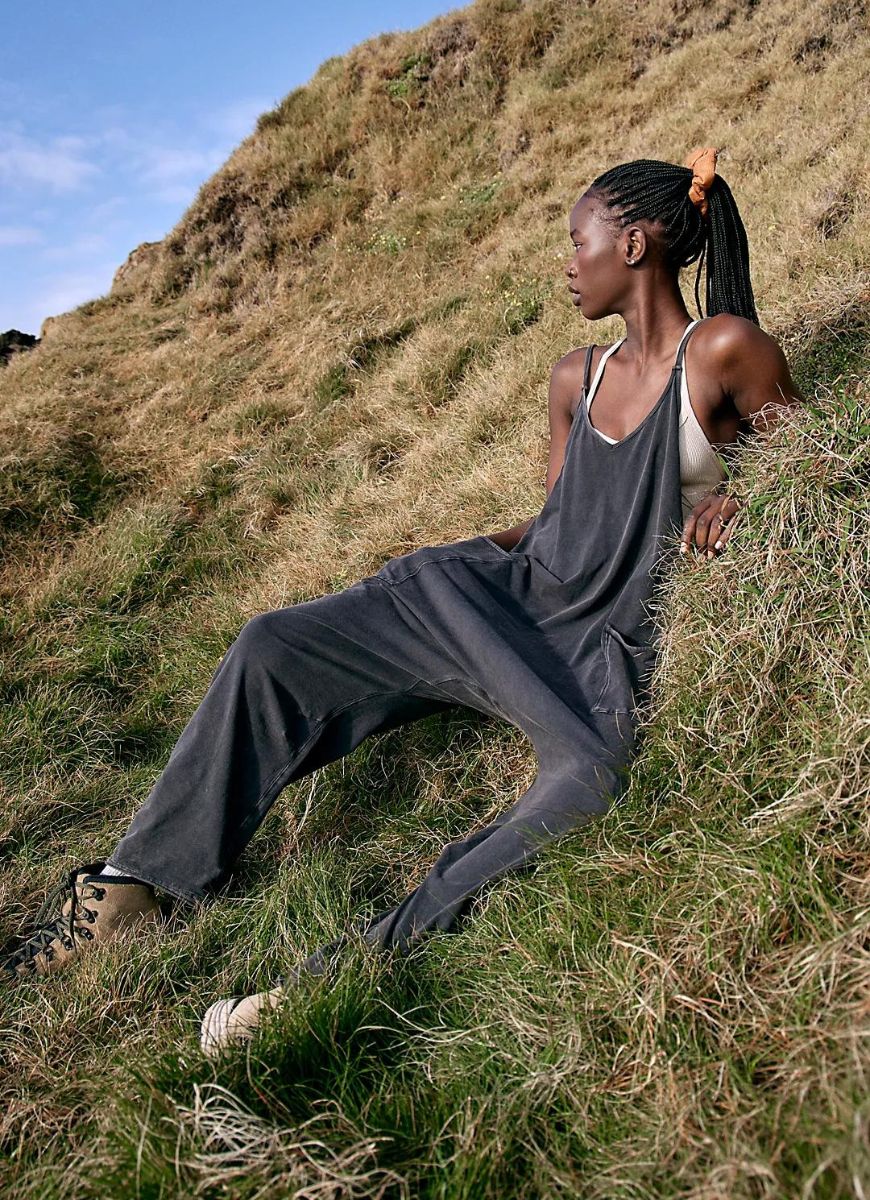 Free People Hot Shot Onesie in Washed Black Model Sitting on the Side of a Hill