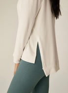 Beyond Yoga Long Weekend Lounge Pullover in Fresh Snow Close Up Side View of Slit