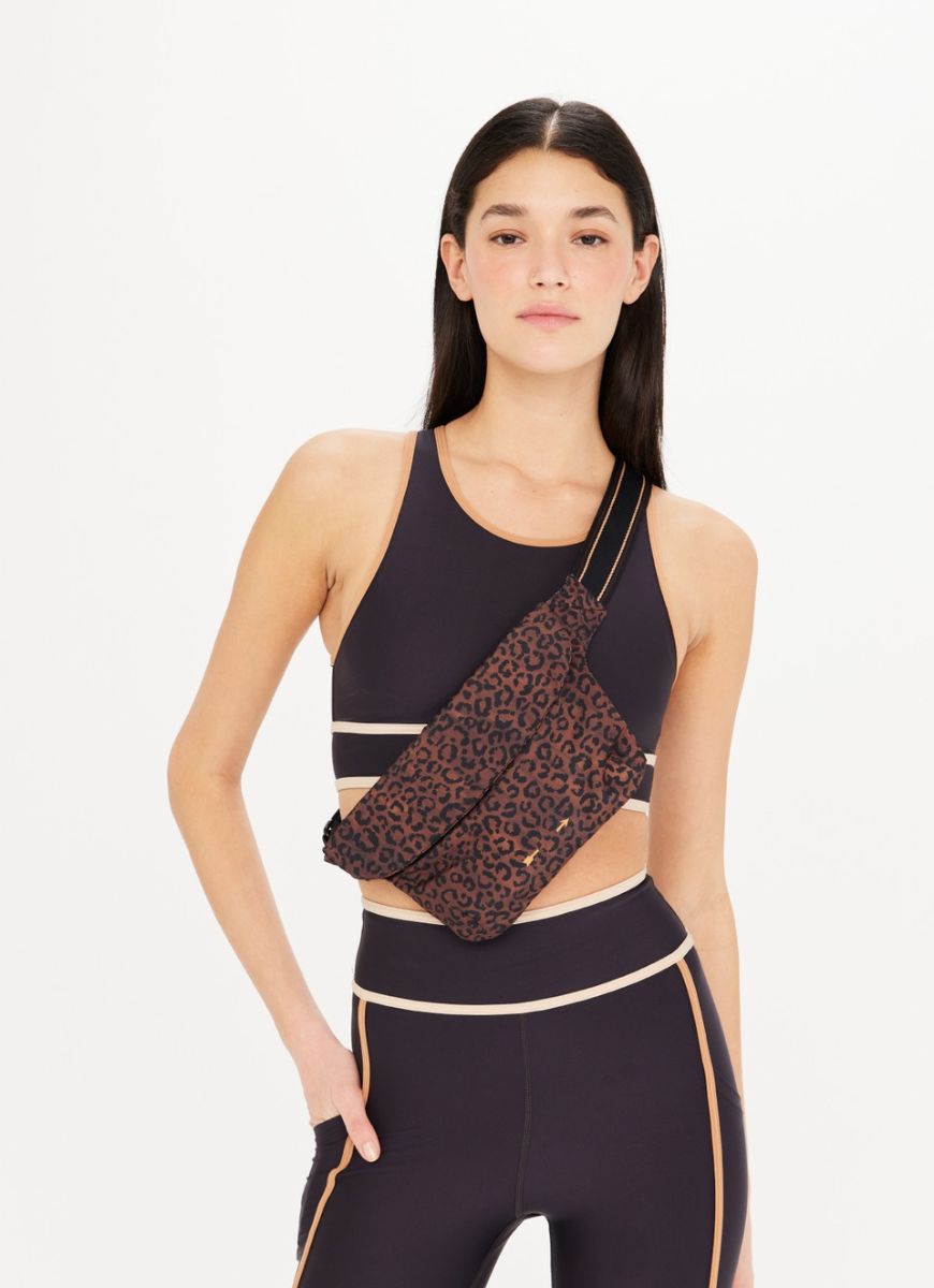 The Upside Women's Malo Belt Bag in Leopard Front View Worn Cross Body