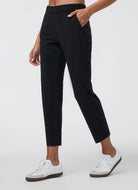 Vuori Women's Miles Ankle Pant in Black Side View With Hand in Pocket