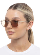 Le Specs Neptune Deux Sunglasses in Gold/Light Brown Shown on Model Side View