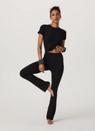 Vuori Women's Pose Fitted Tee in Black Full Length Front View With Model in a Pose