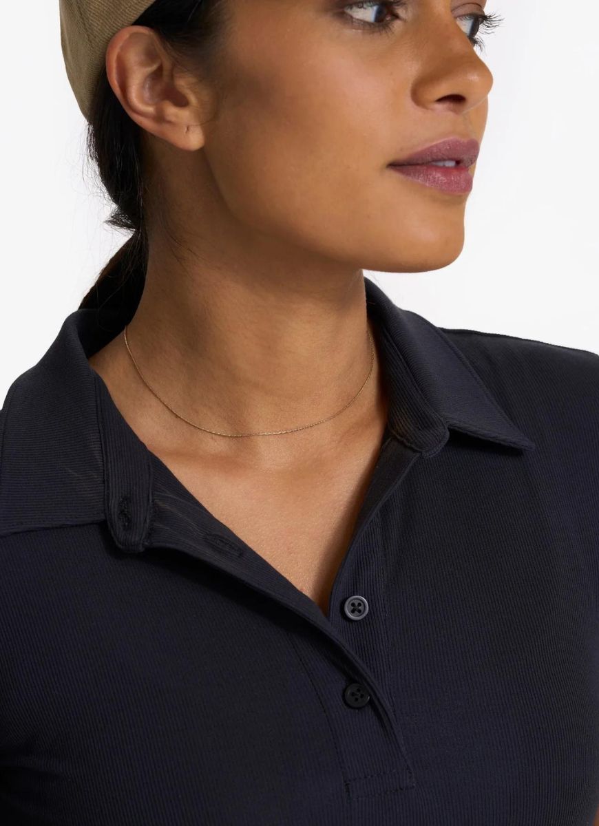 Vuori Women's Pose Fitted Polo in Black Close Up Front View of Collar