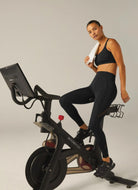 Beyond Yoga Powerbeyond Bootcamp Midi Legging in Black Model Shown on Spin Bike