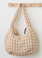 Free People Quilted Carryall Bag in Off White Front View Hanging on a Hook