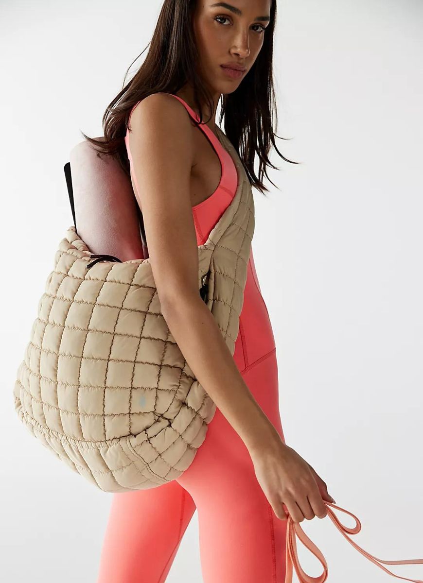 Free People Quilted Carryall Bag in Off White Shown on Model Wearing Over Shoulder