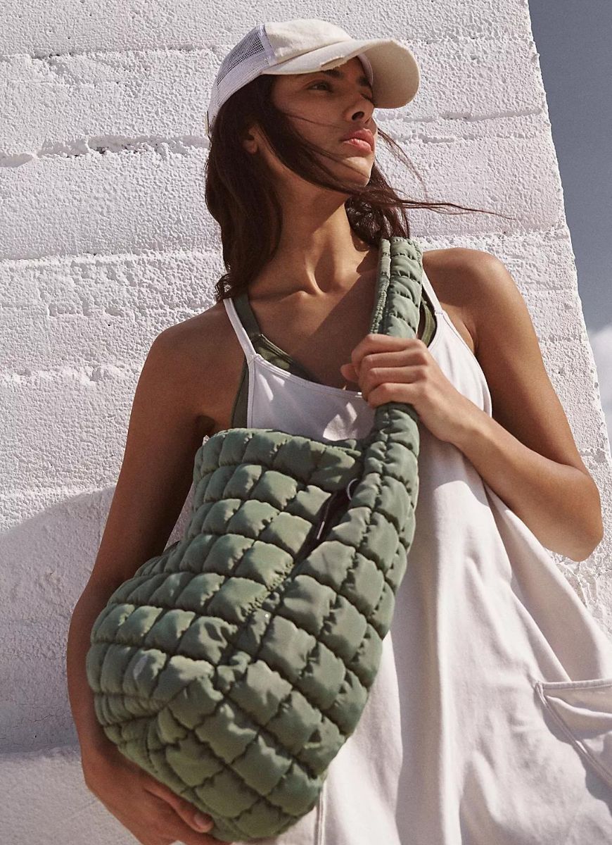 Free People Quilted Carryall Bag in Washed Sage Shown on Model Wearing the Bag Crossbody 