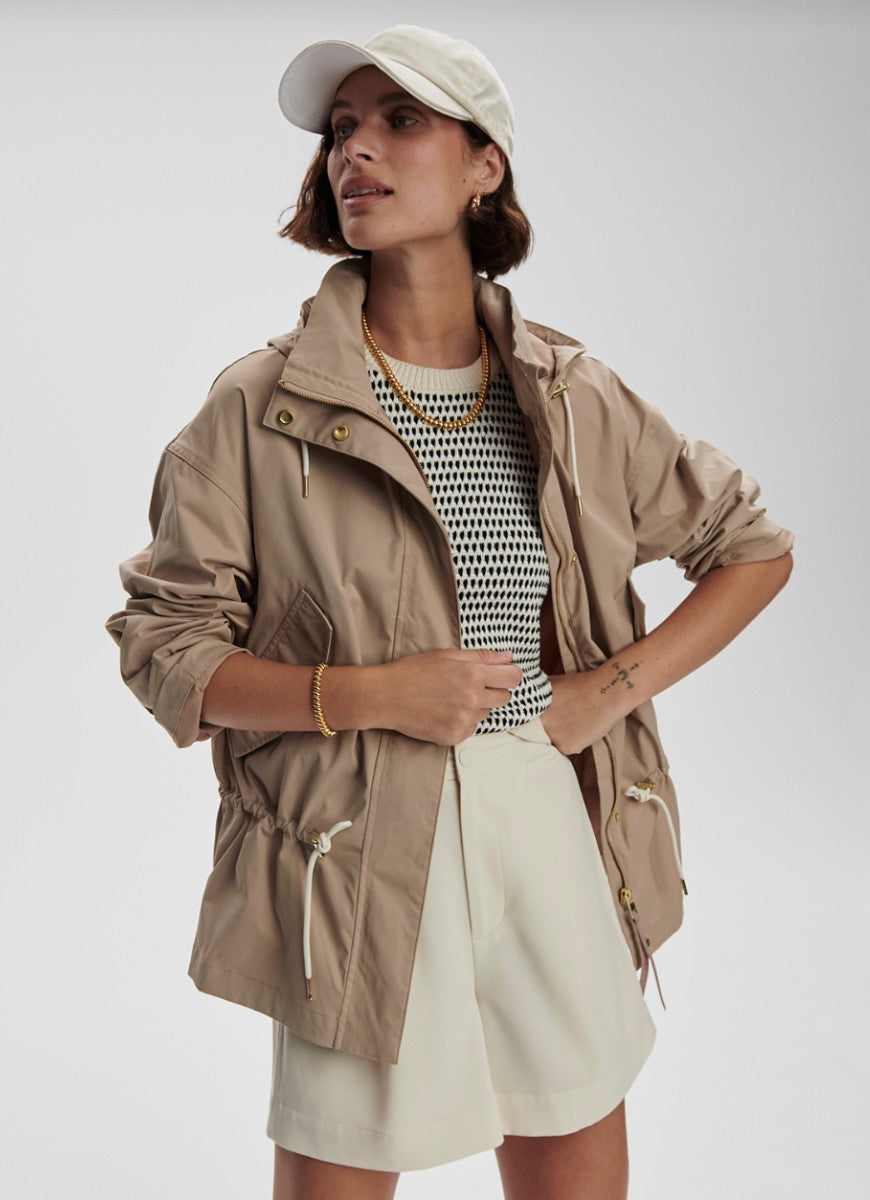 Varley Rema Short Rain Jacket in Light Taupe Front View With Model in a Pose