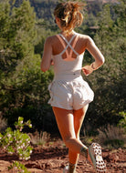 Free People Righteous Runsie in Mineral Bath Back View Showing Model Running on a Trail