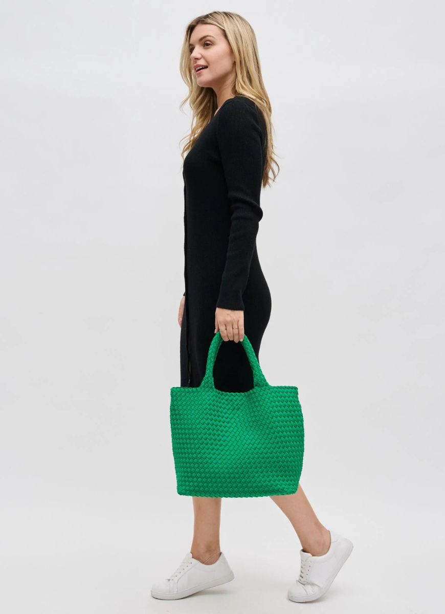 Sol and Selene Sky’s The Limit Medium Tote in Kelly Green Side View with Model Holding the Bag by it's Handles