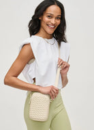 SOL AND SELENE Divide & Conquer Woven Neoprene Crossbody in Cream Modeling Shown Carrying Bag
