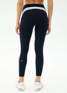 Person wearing navy leggings with a white stripe on a white background