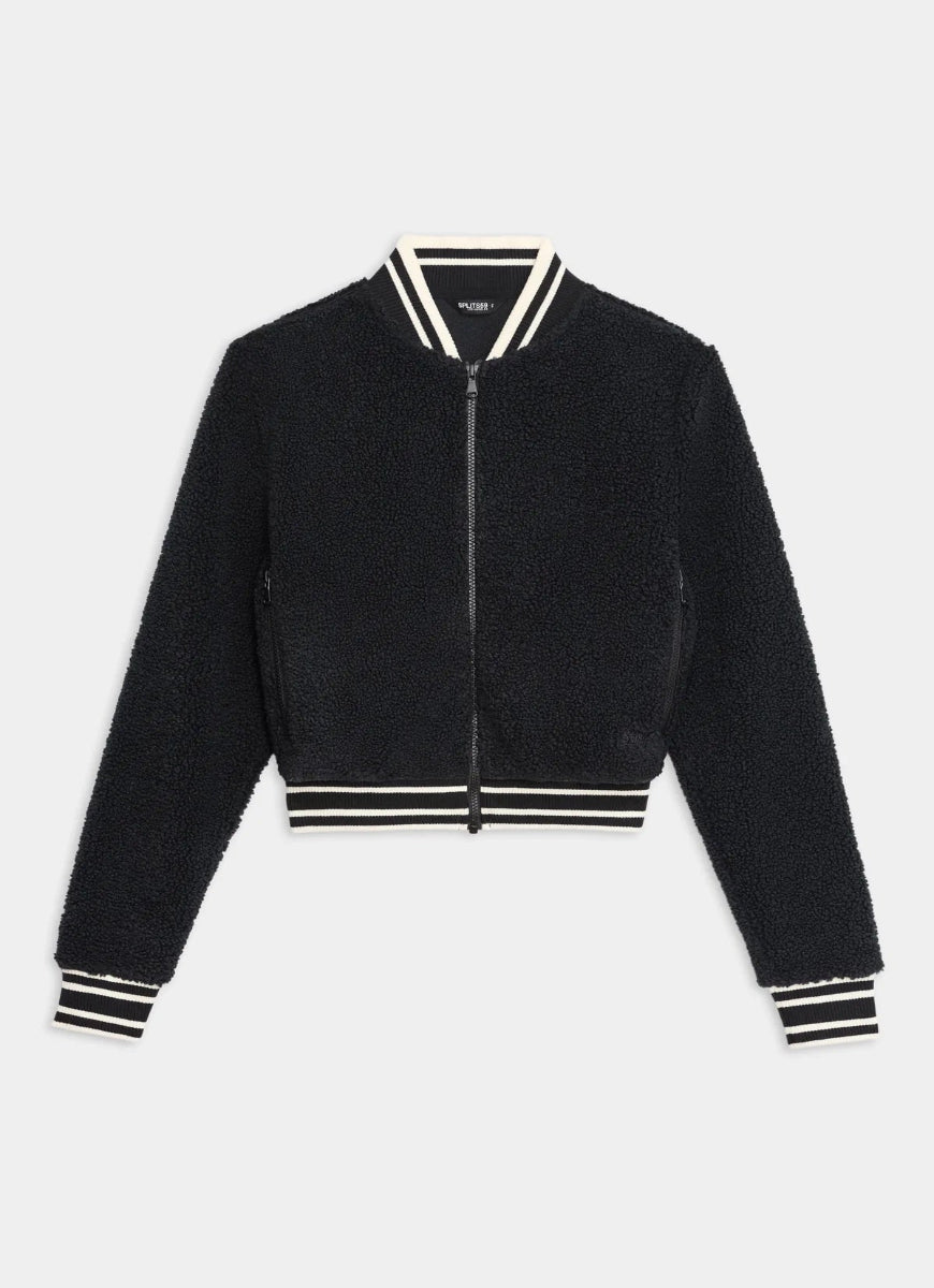 Black bomber jacket with white and black striped trim on a light gray background