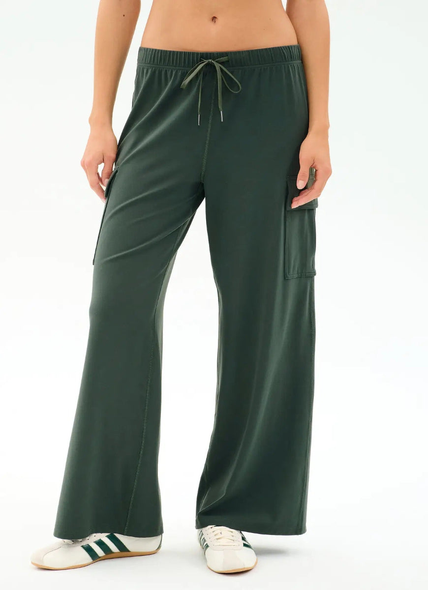 Green wide-leg pants worn by a person on a white background