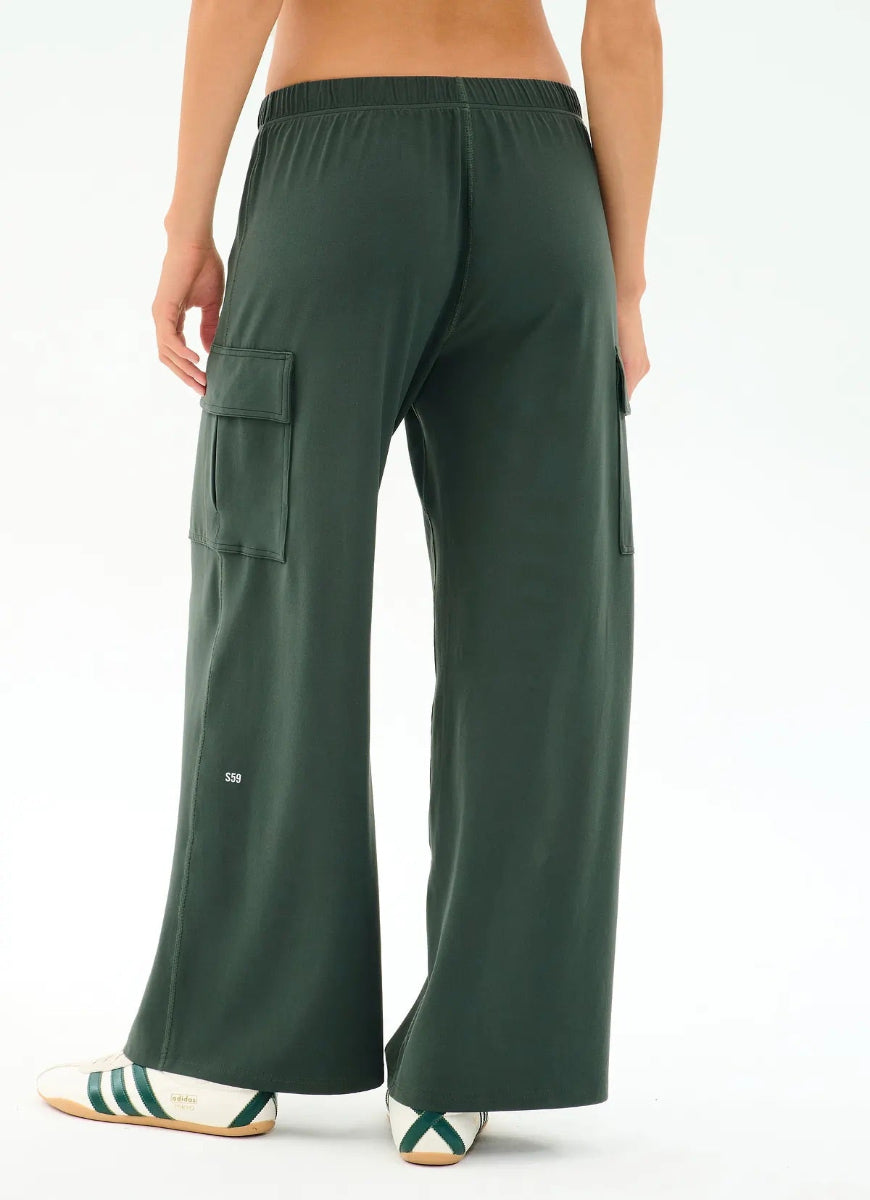 Green cargo pants worn by a person on a white background