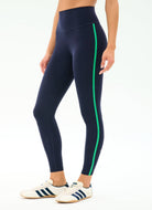 Navy leggings with green stripes worn by a person on a white background
