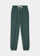 Green sweatpants with a drawstring on a light gray background