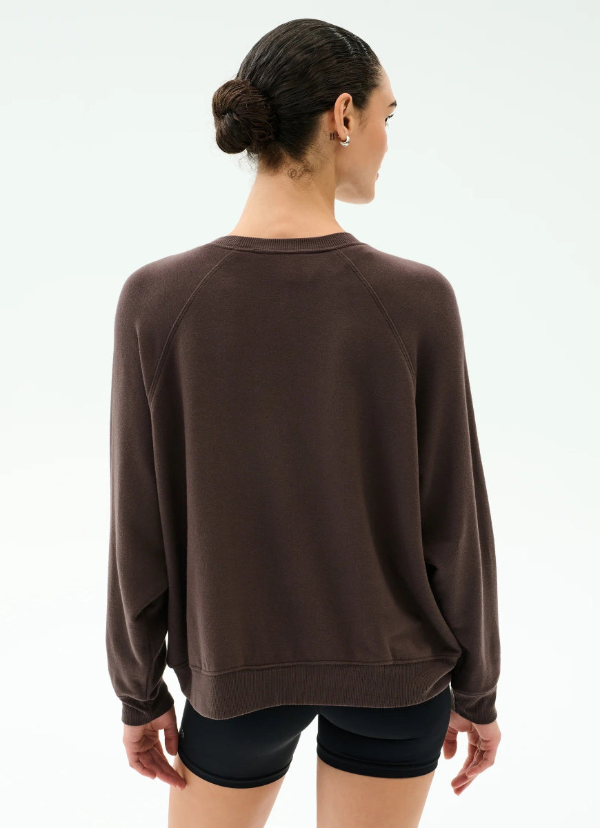 Woman wearing a brown sweatshirt on a white background