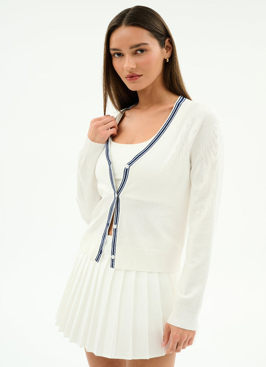 Woman wearing a white dress with a blue ribbon on a white background