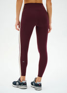 Maroon leggings with a white stripe on a white background