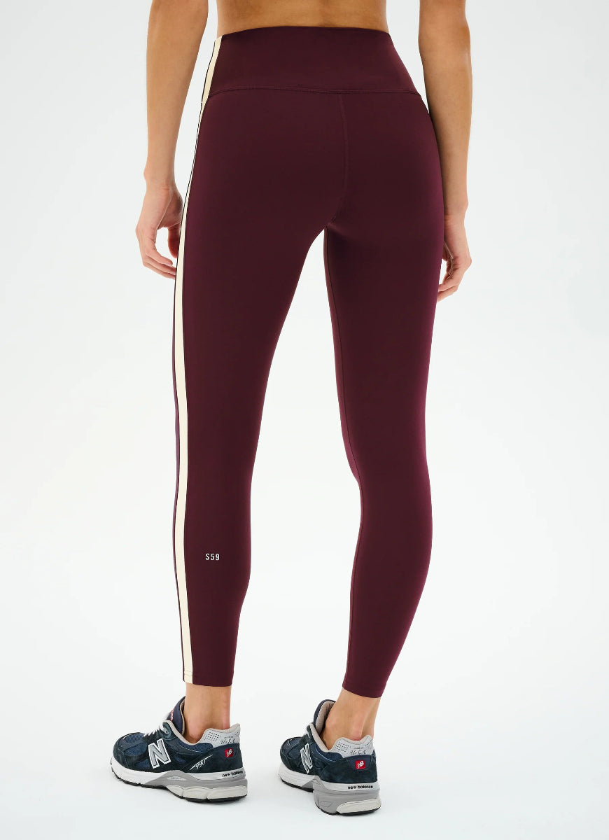 Maroon leggings with a white stripe on a white background