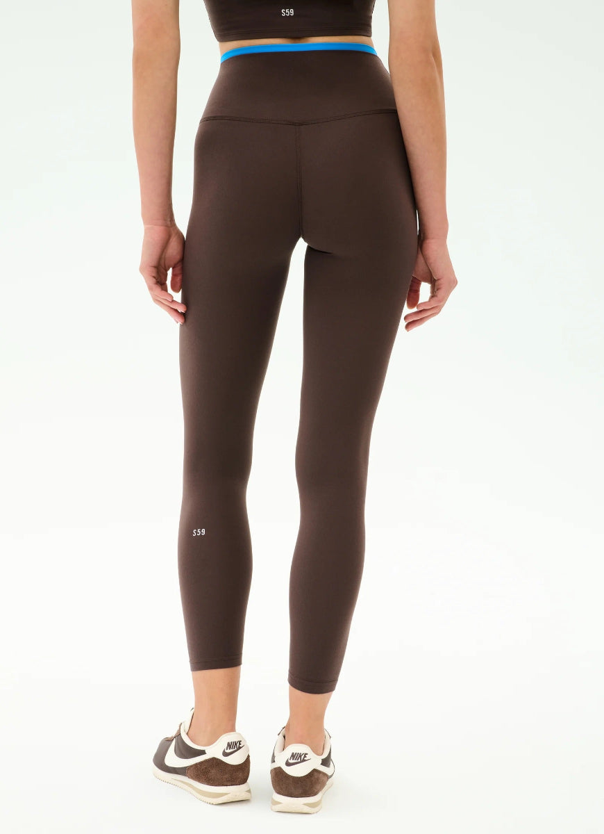 Brown leggings worn by a person on a white background