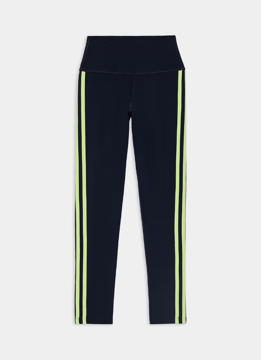 Navy blue athletic leggings with two vertical lime green stripes down the sides, shown flat against a light gray background.