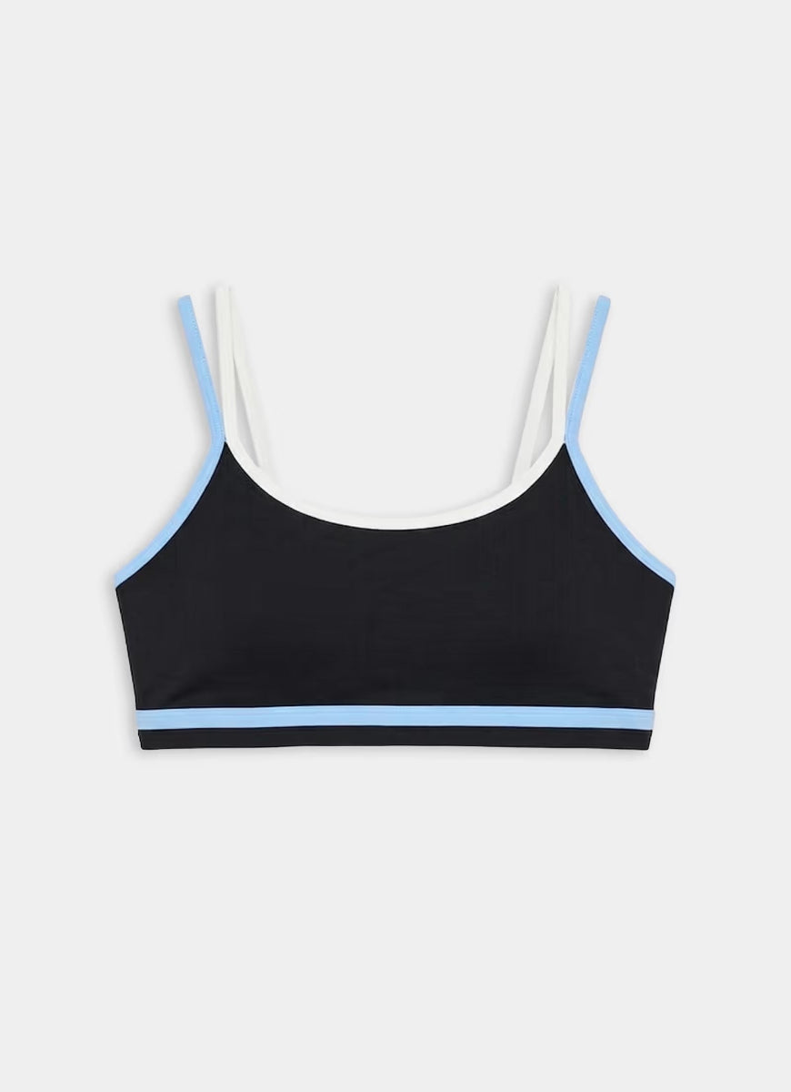 Black sports bra with white and blue trim on a light gray background