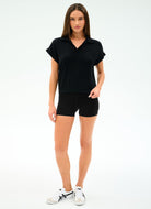 Woman wearing a black outfit with a plain background